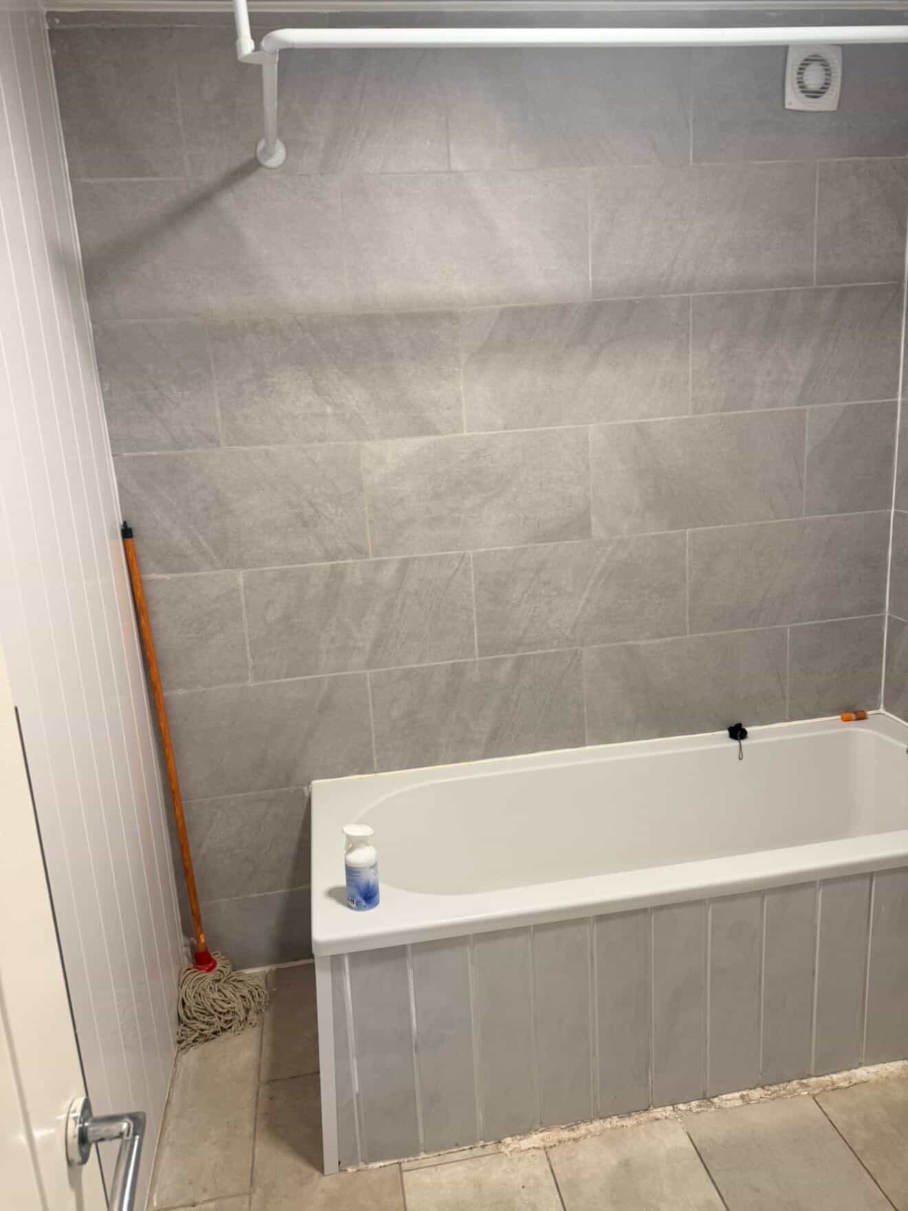 Bathroom bath and shower area before a detailed clean.