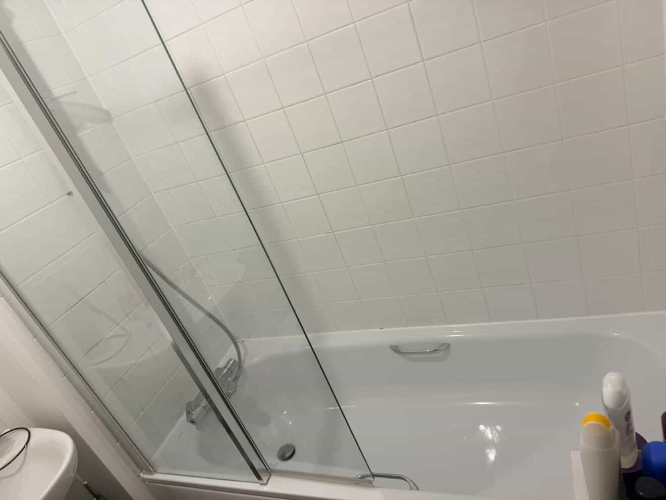 Bathroom bath and wall tiles after a deep clean.