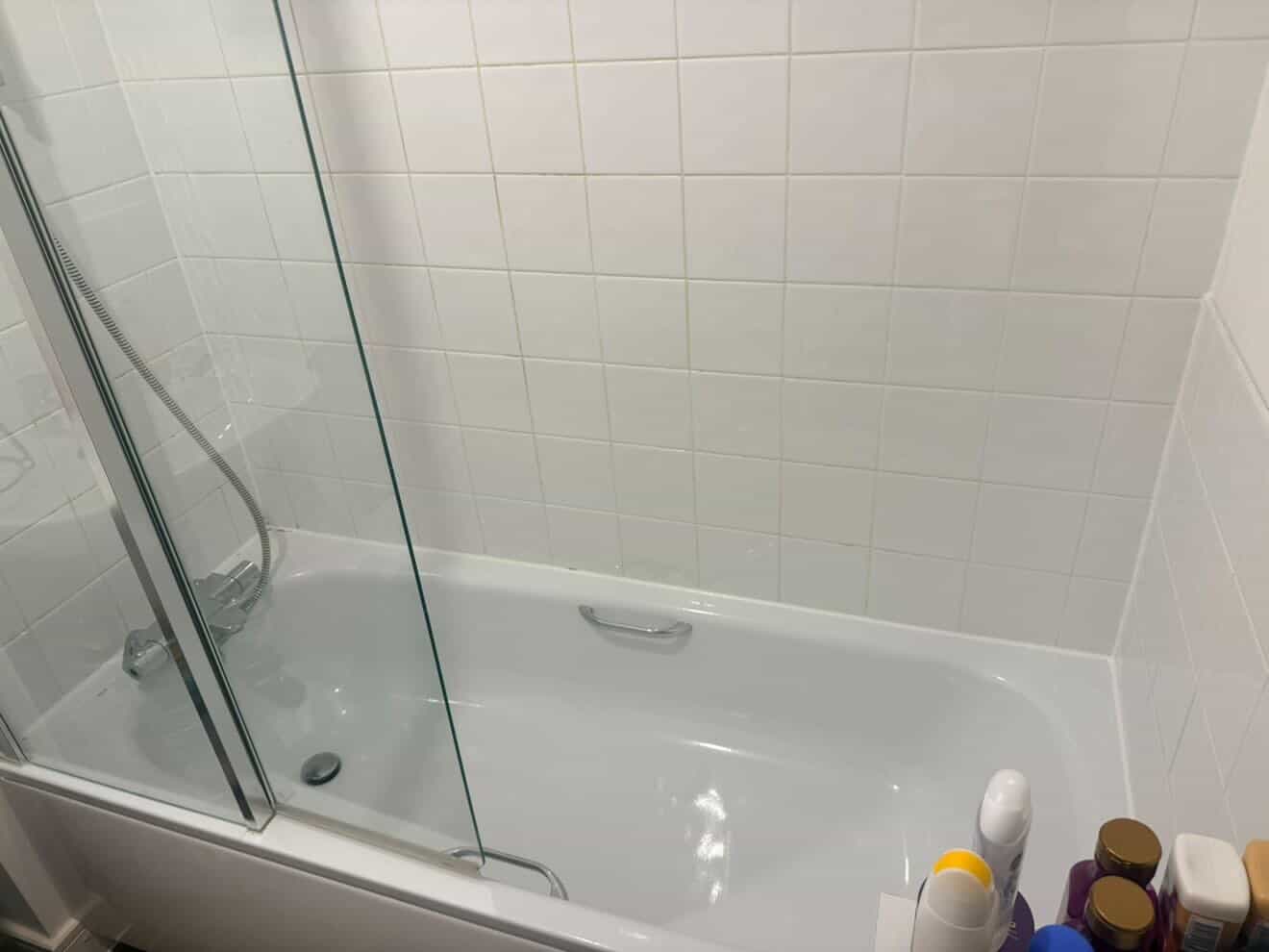 Bathroom sink and bath area after a deep clean.