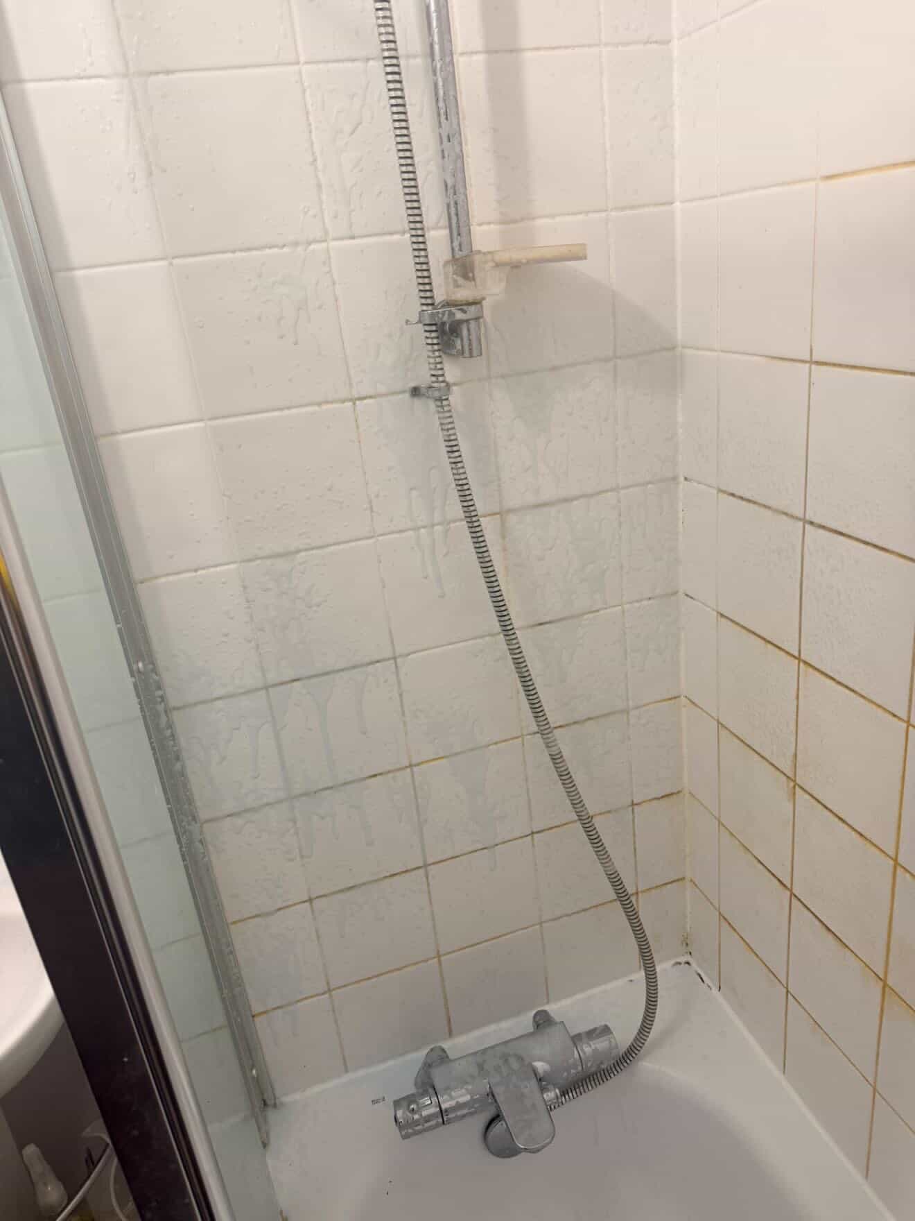 Bathroom bath and wall tiles before a deep clean.