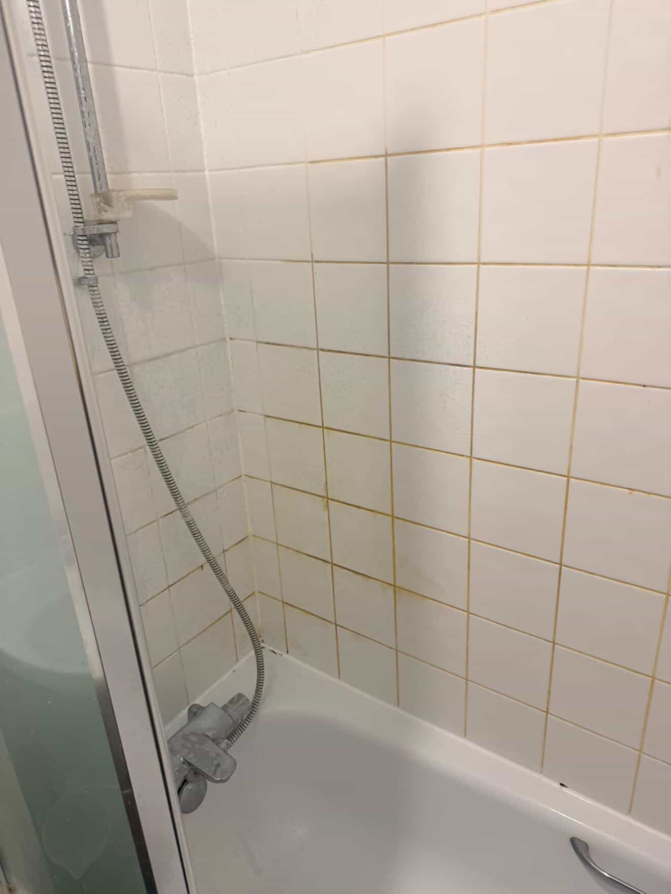 Bathroom sink and bath area before a deep clean.