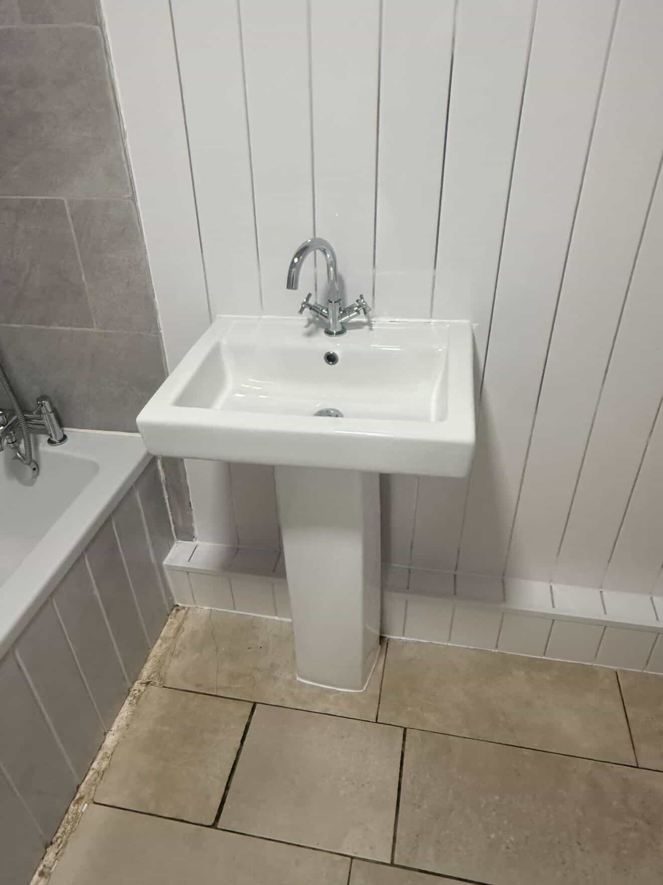 Bathroom sink and bath area after a detailed clean.