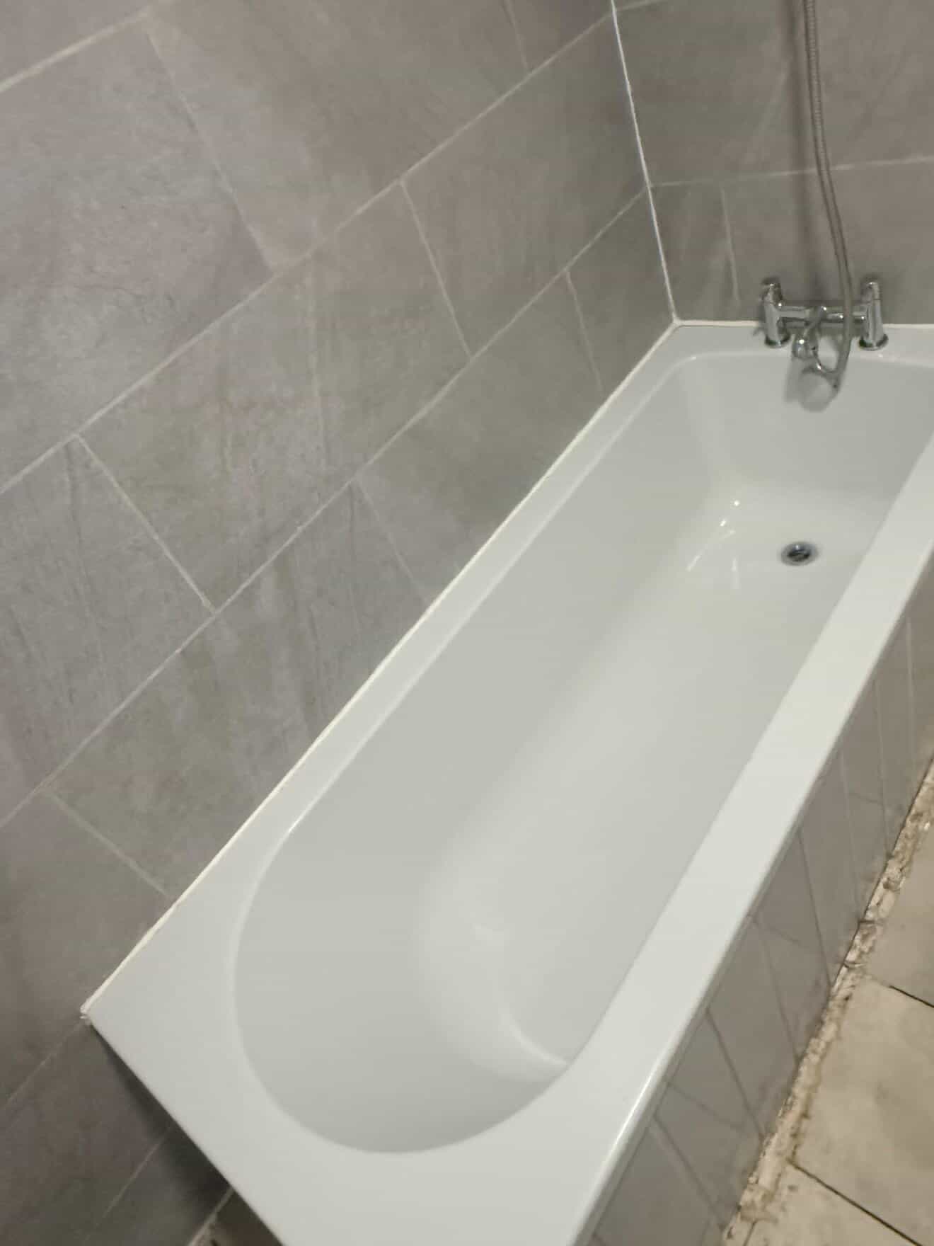 Bathroom bath and shower area after a detailed clean.